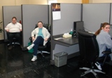 Wiscraft's three Communication Center agents sitting at their cubicles.