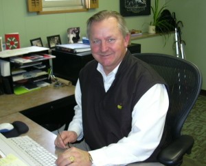 A picture of Wiscraft's President and CEO, Jim Kerlin, sitting at his desk