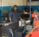 Mike shown at one of his many stations, the saw machine.