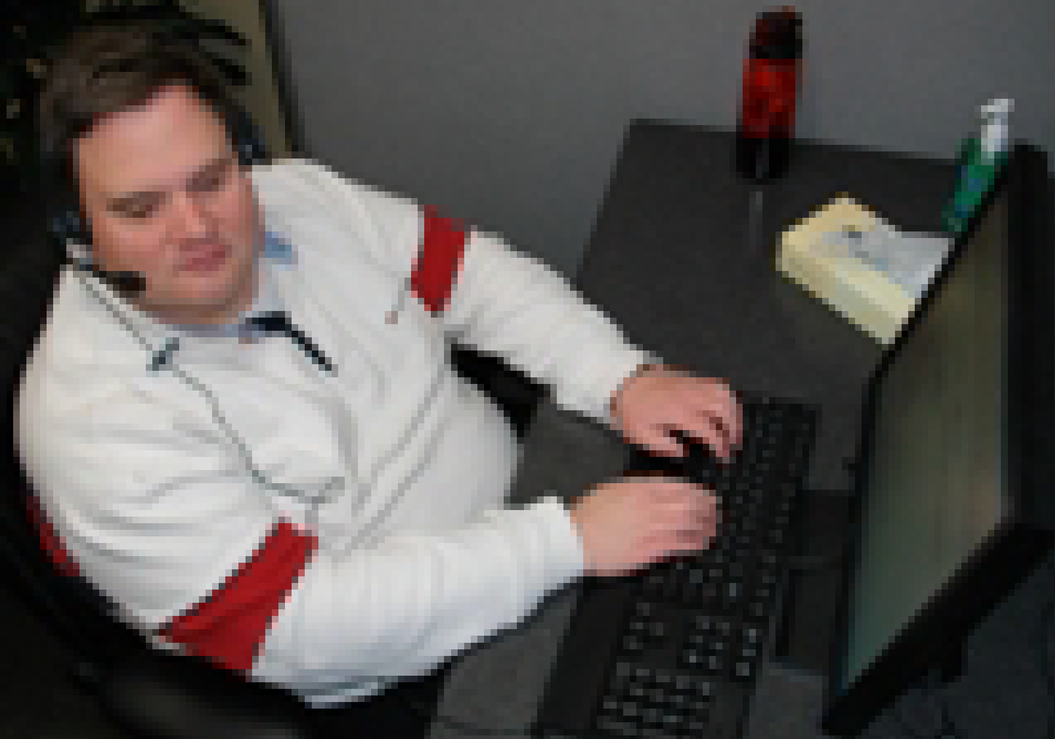 Steven, adorned with his headset, working at his computer.