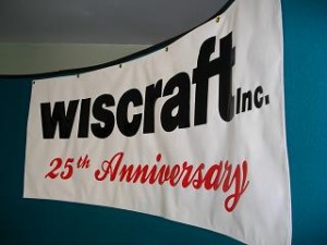 A banner is hanging from a wall that says - wiscraft 25th anniversary
