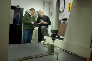 Engineers measuring a manufactured part
