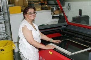 IMG_0264 Sophia stands at the privacy filter cutting machine.