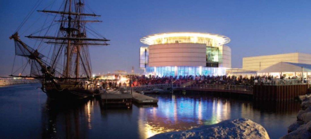 the Denis Sullivan sits in the harbor by the Discovery World Museum at sunset.