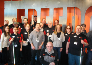 Beyond Vision employees group photo with Harley Davidson