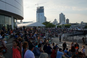 The sun is setting over the crowd at Live at the Lakefront