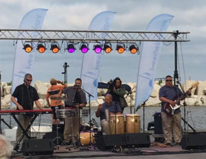 Los Ciegos del Barrio perform on a pier on the edge of Lake Michigan.