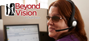 Logo for Beyond Vision with a picture of a woman who is blind smiling as she wears a phone headset in front of a computer.