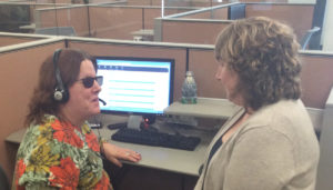 Mary Lapointe and Deb Wenzel are chatting at Deb's cubicle.