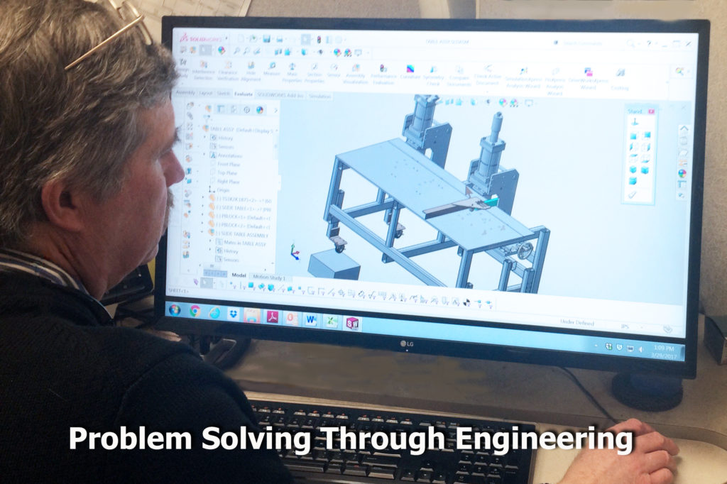 An engineer who is visually impaired sits in front of an enlarged screen with a machine drawing on the screen. "Problem solving through engineering."