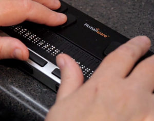 a pair of hands on a braille reader