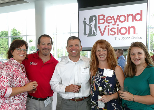 Beyond Vision employee Egon standing next to guest at the pavilion 