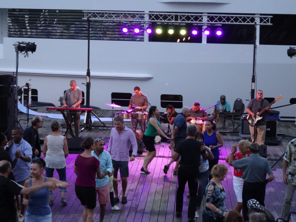 Los Ciegos del Barrio performing in front of a crowd of dancing people