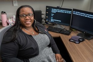 Delonna Williams sitting at her desk