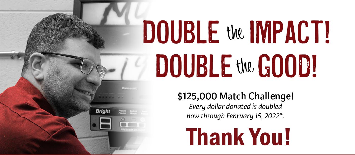 A visually impaired man is using a magnifier. Text - double the impact, double the good. $125,000 March challenge. Thank you!