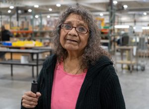 Photo of Sophia Kipp in Beyond Vision's manufacturing area.