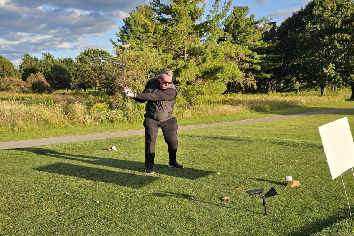 Rob Buettner swinging a golf club.