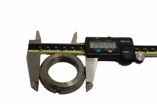 Circular steel ring being measured with a caliper 
