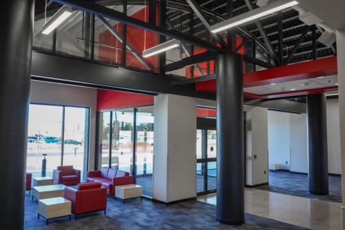 Entrance when walking into the VisABILITY Center. Exposed support beams and pillars with a modern seating area.